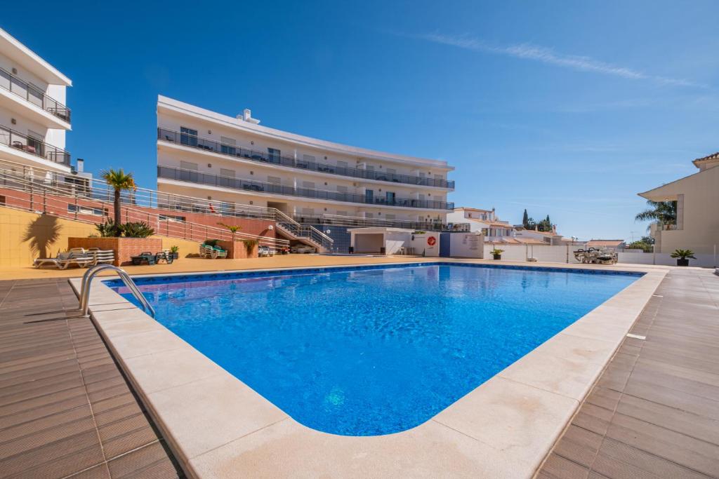 a swimming pool in front of a building at Solarium Luxury Apartment by Atlantic Places in Albufeira