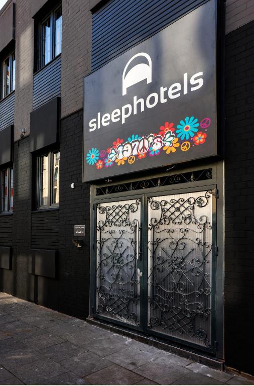 a sign above a gate in front of a building at Sleephotels 1970s in Hamburg