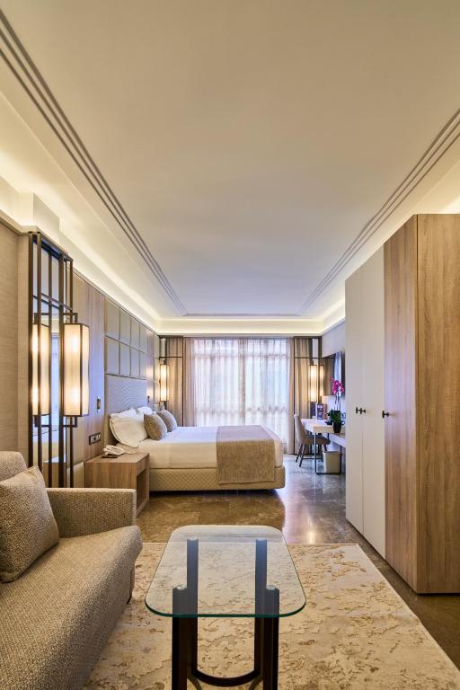 a hotel room with a bed and a table at VP Madroño in Madrid
