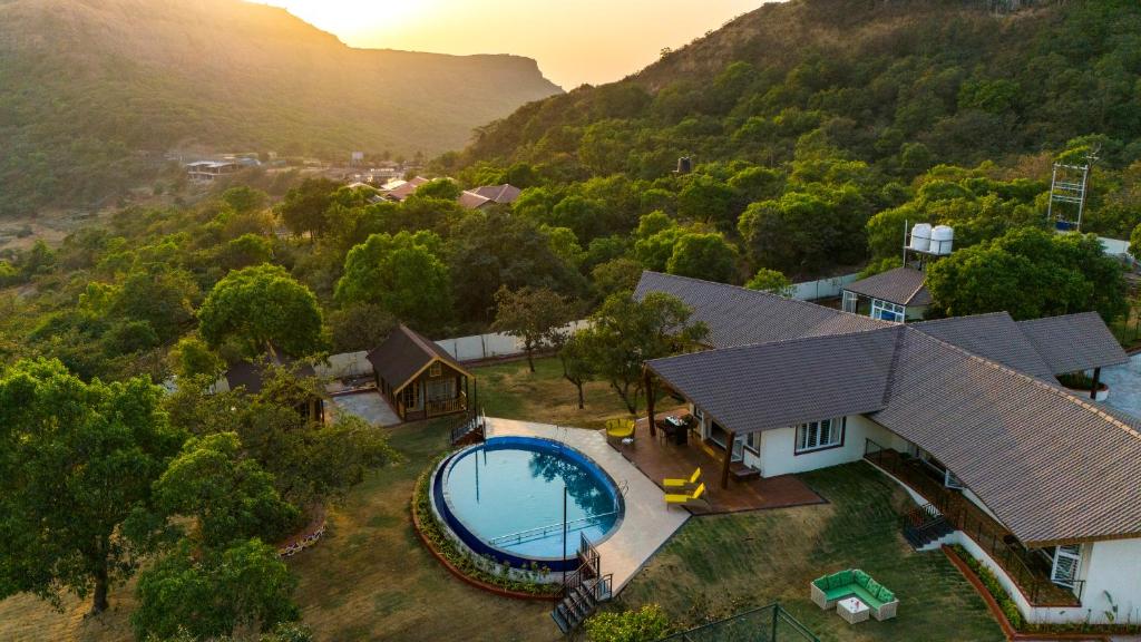 an aerial view of a house with a swimming pool at SaffronStays Eagle's Span in Malavli