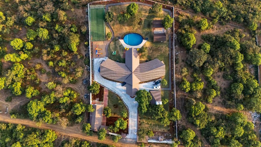 an overhead view of a park with a water tower at SaffronStays Eagle's Span in Malavli