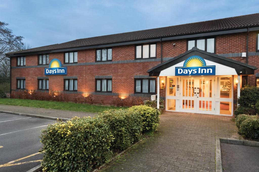 a building with a sign on the side of it at Days Inn Michaelwood M5 in Falfield