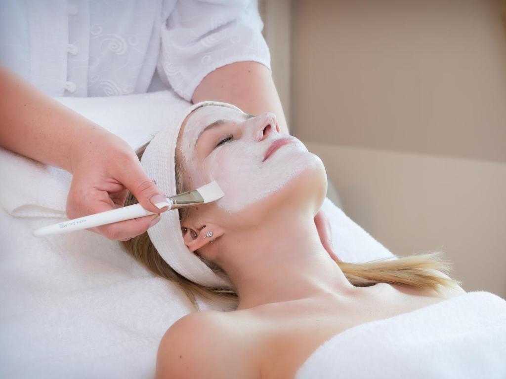 a woman getting her face rejuvenated at a spa at Hotel Klosterhotel Ludwig der Bayer in Ettal