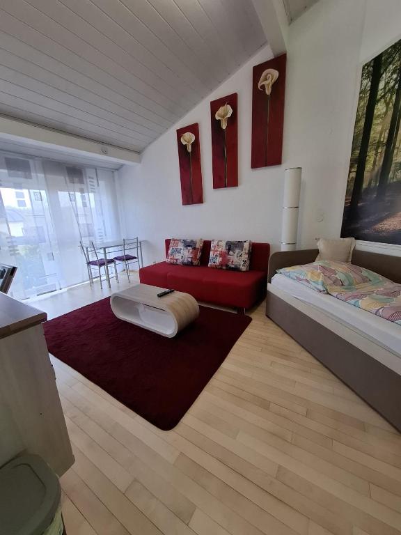 a living room with a bed and a couch at Exclusive Apartments in Bietigheim-Bissingen