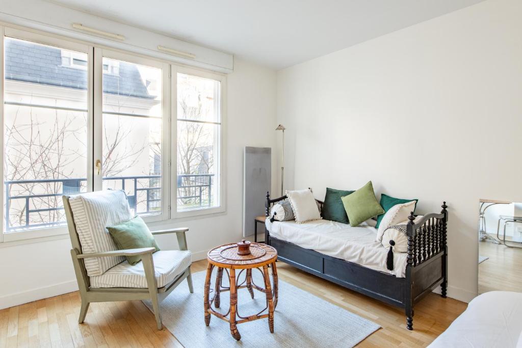 un salon avec un canapé et une chaise dans l'établissement Dames - Studio lumineux Gare Saint-Lazare, à Paris