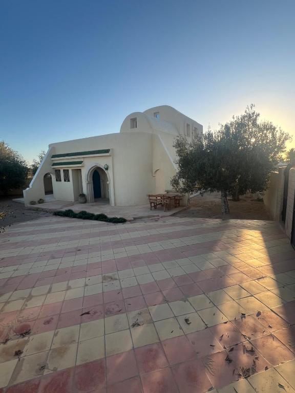 a building with a table in front of it at Dream Villa with Private Pool in Taguermess