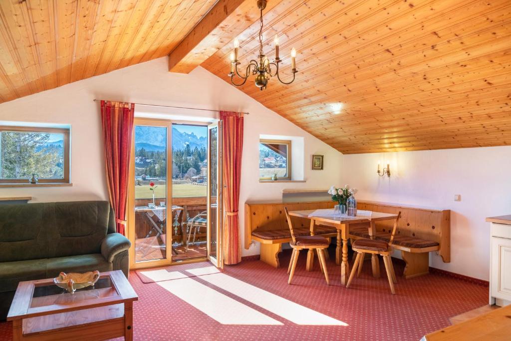 a living room with a table and a couch at Alpenblick Tilly Fewo Walchensee 5 in Krün