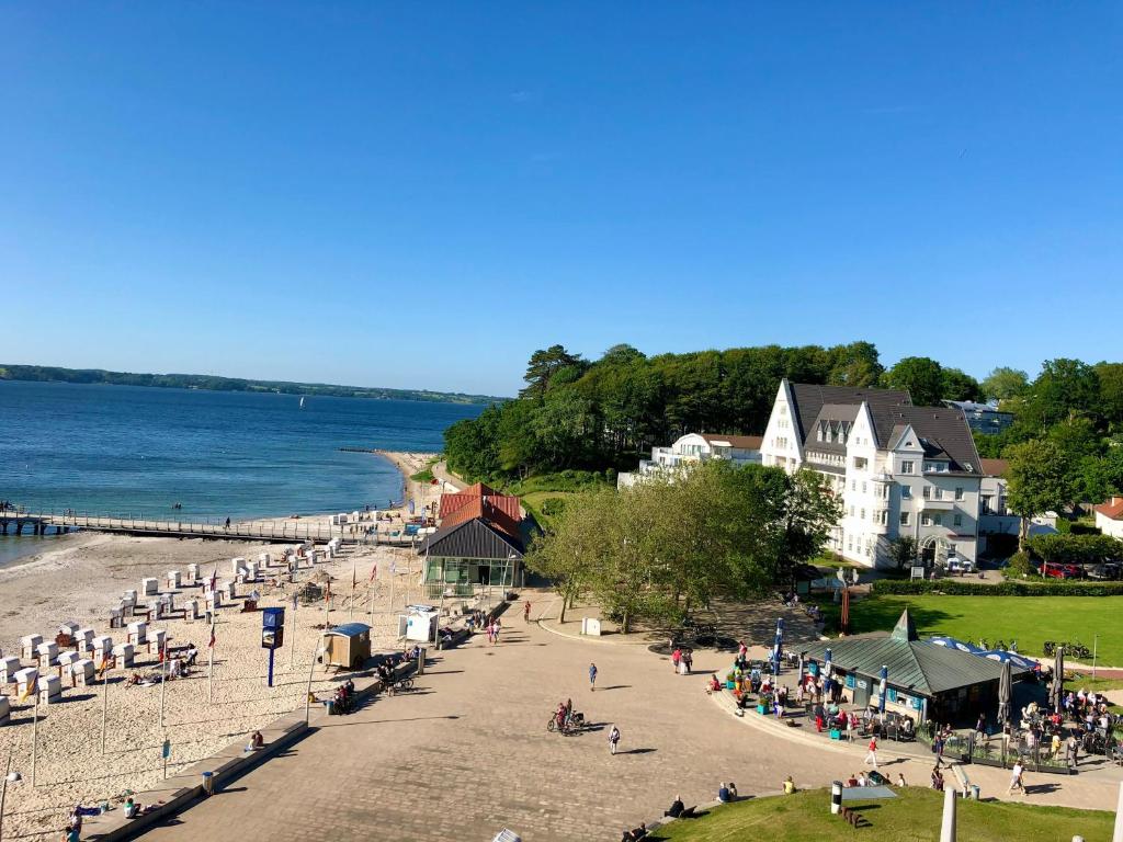 eine Gruppe von Menschen an einem Strand in der Nähe des Wassers in der Unterkunft Ferienapartment schön hier in Glücksburg