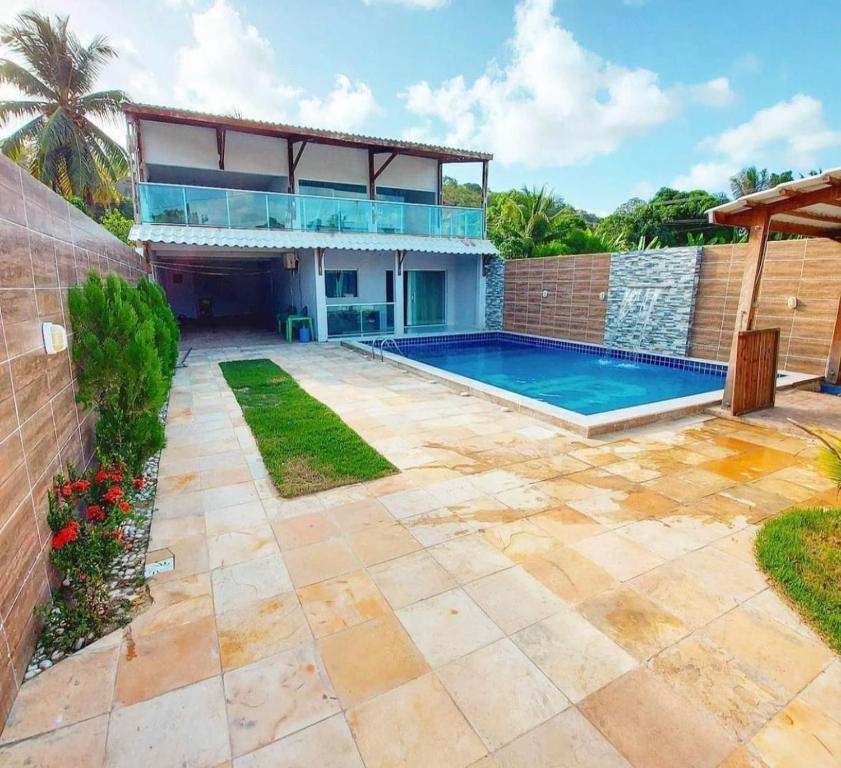 a swimming pool in the backyard of a house at Wcasadepraia in Maragogi
