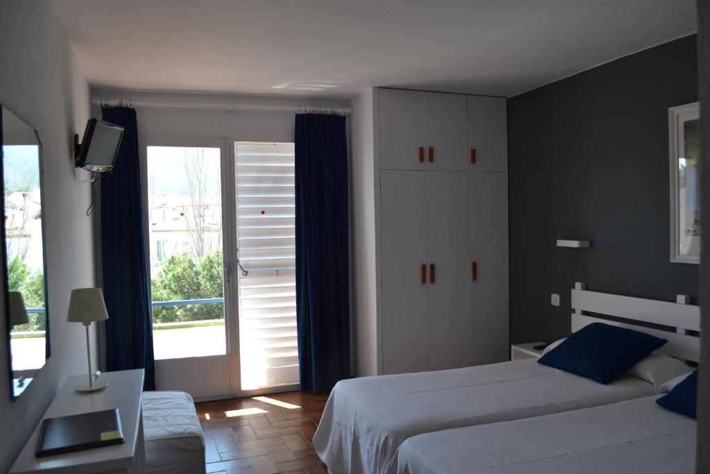Postel nebo postele na pokoji v ubytování Hotel S´Aguarda