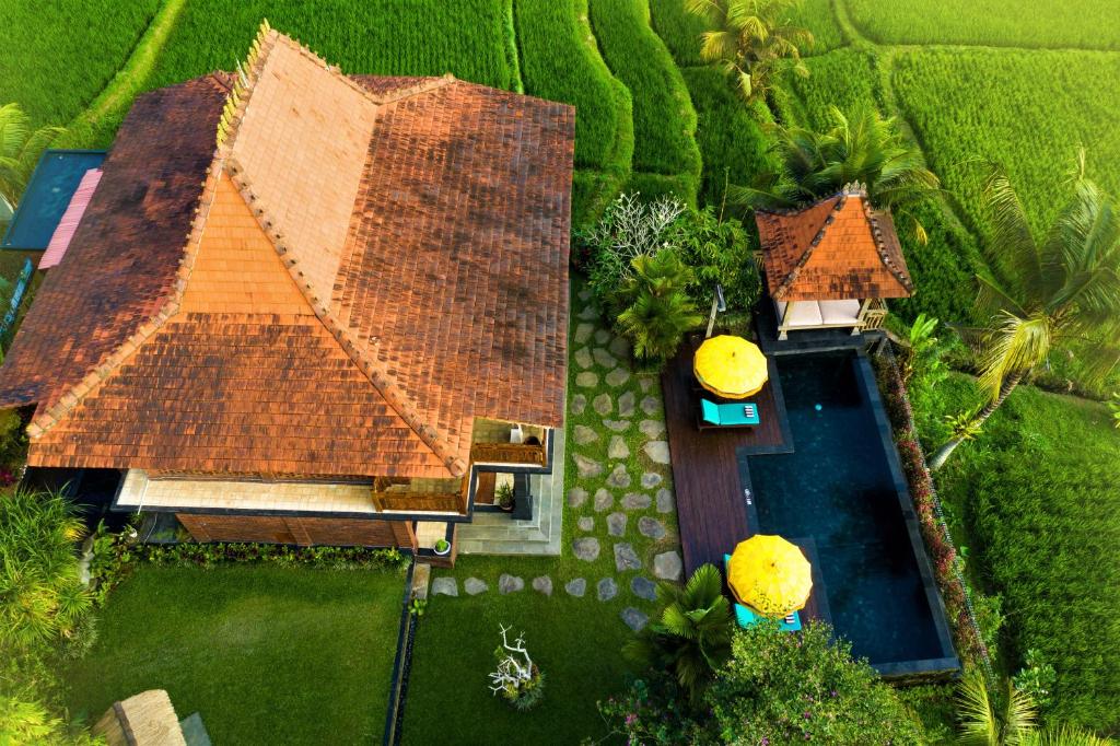 an overhead view of a house with a swimming pool at The Joglo at Umah Sunset in Ubud