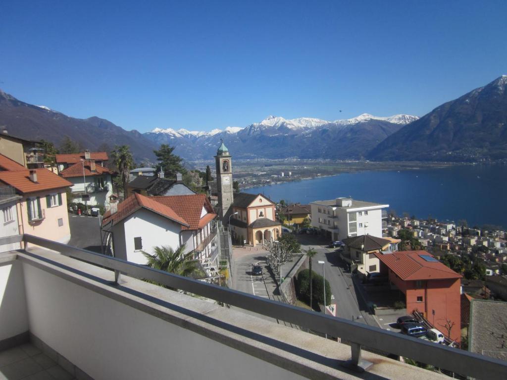 a view of a town with a lake and mountains at Casa Franceschini in Locarno