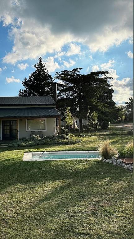 a house with a swimming pool in the yard at La Pasiva in Villa Giardino