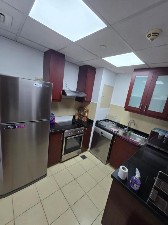 a large kitchen with a stainless steel refrigerator at النزهة2 in Cairo