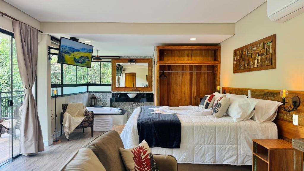 a bedroom with a bed and a living room at Villa Tirol - Monte Verde in Monte Verde