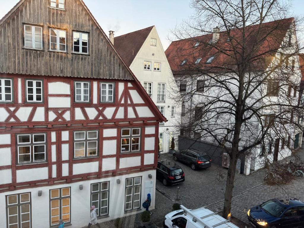 an apartment building with cars parked in a parking lot at Historisches Fischerviertel in Ulm