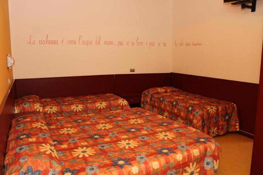 Postel nebo postele na pokoji v ubytování Meublé Nautic Rooms b&b