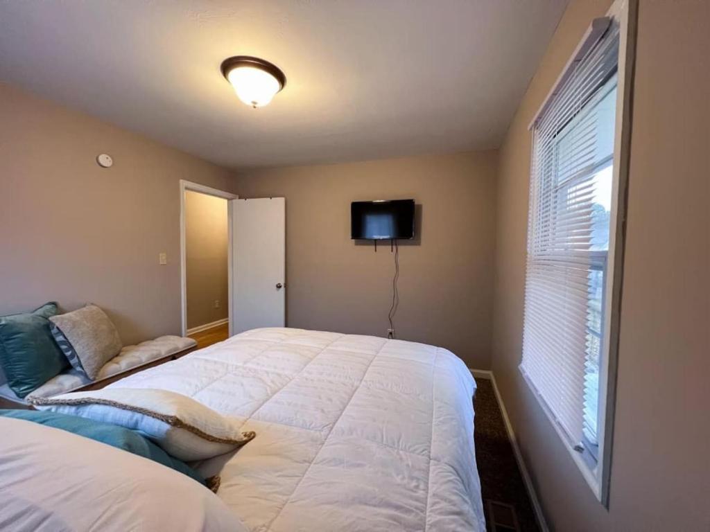 a bedroom with a large white bed and a window at 318) Extended Stay in Newport News