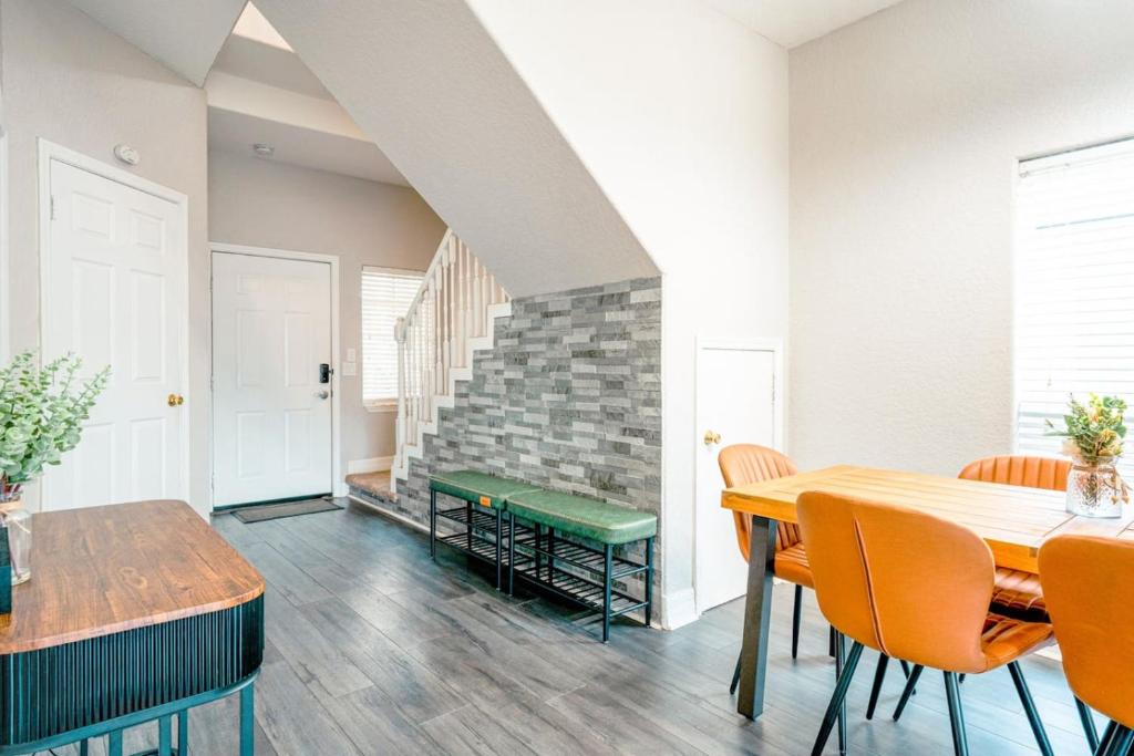 a dining room with a table and chairs at Full House HotTub Mins to UCF in Bithlo