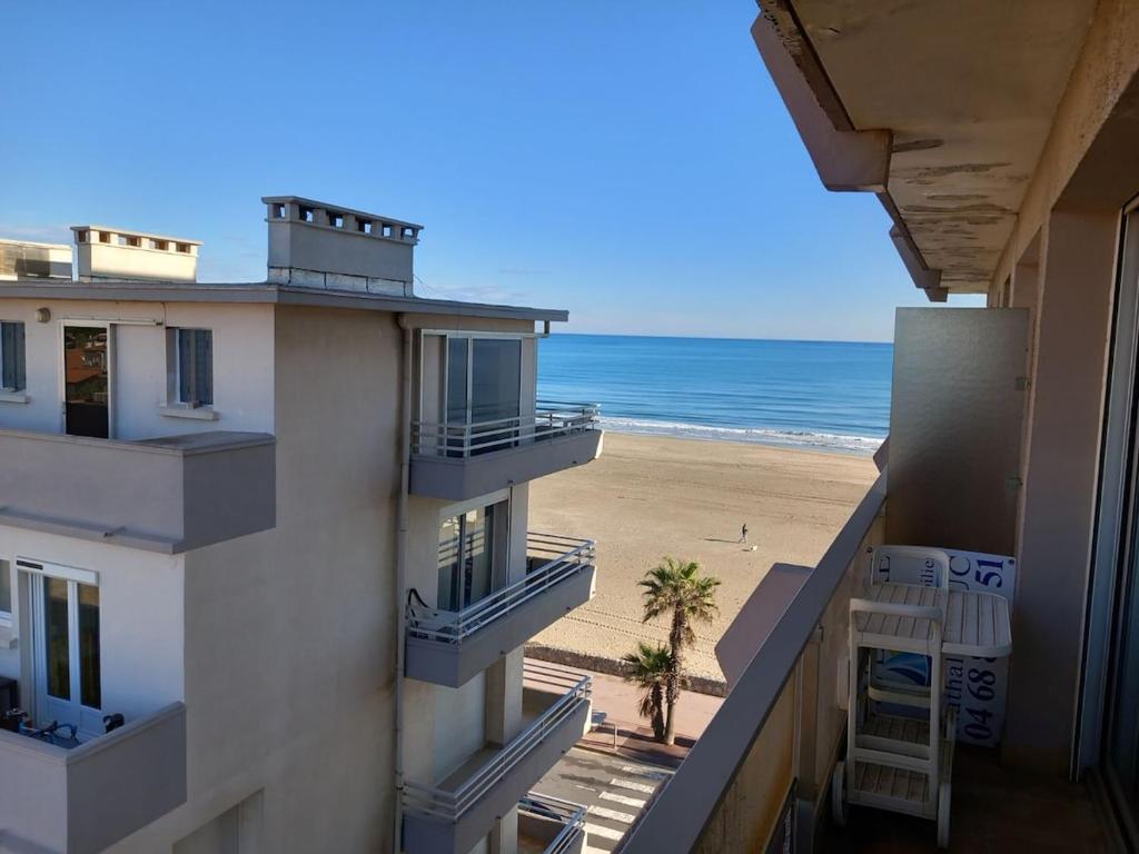 a view of the beach from the balcony of a building at T2 Vue latérale Mer 1 Ligne clim in Canet-en-Roussillon