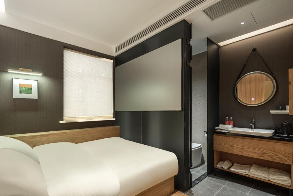 Postel nebo postele na pokoji v ubytování Captain 5 Youth Hotel-Shanghai Laoshan Road Branch