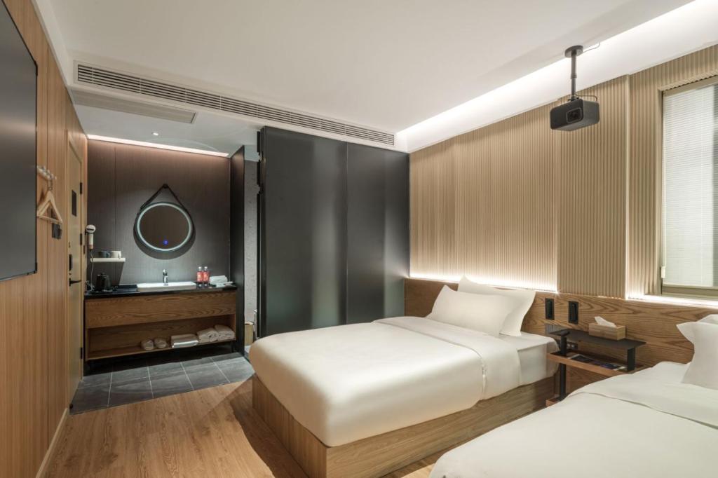 Postel nebo postele na pokoji v ubytování Captain 5 Youth Hotel-Shanghai Laoshan Road Branch