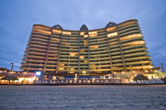 a large building on the beach at night at Sonoran Sky in Puerto Peñasco