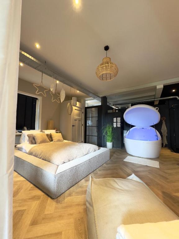 a large bedroom with two beds and a table at Sparkle privé wellness B&B in Franeker