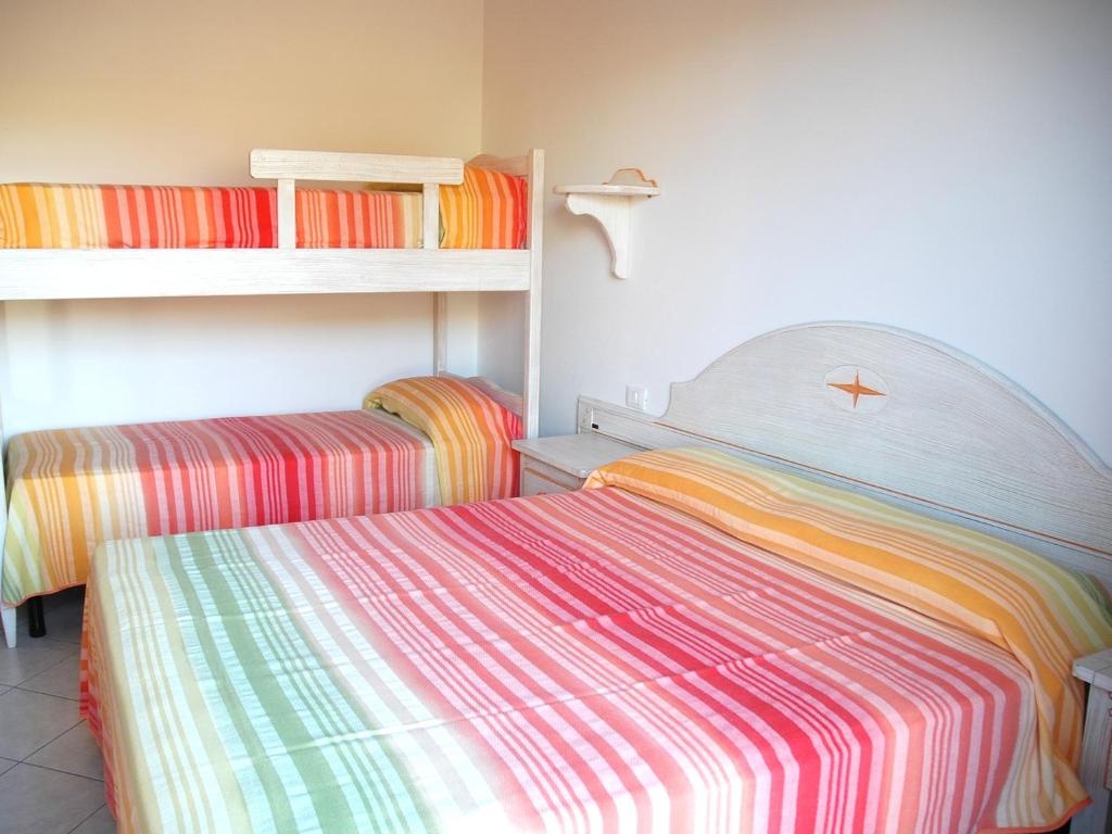A bed or beds in a room at Baia Fiorita