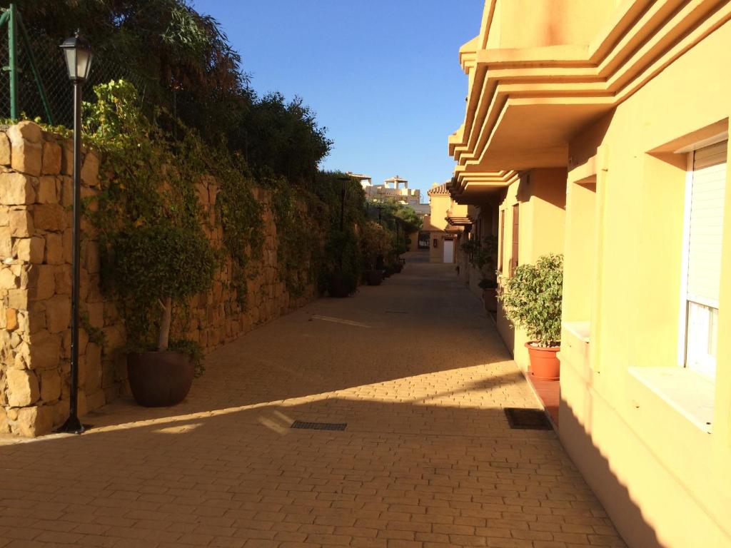 an empty alley with a building and a street at La Galera Park House in Estepona