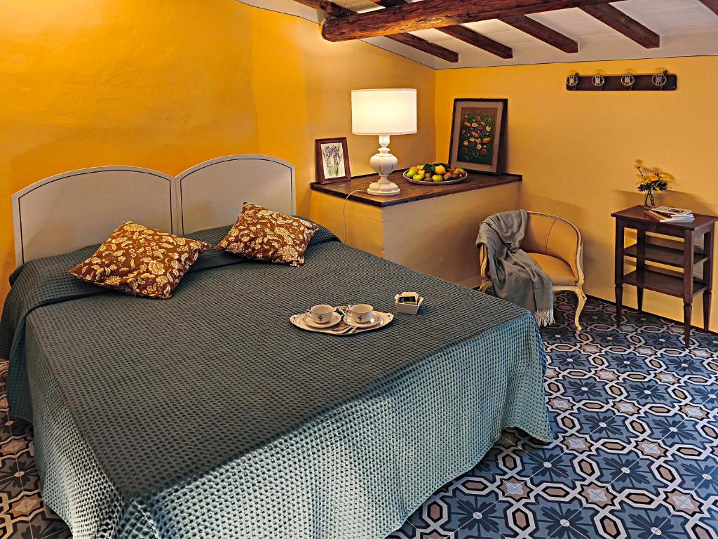 a bedroom with a bed with a plate on it at La Funambola BB in Poggio Alla Croce