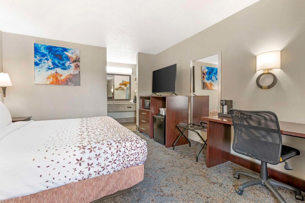 a hotel room with a bed and a desk and a computer at Best Western Royal Inn in Chattanooga