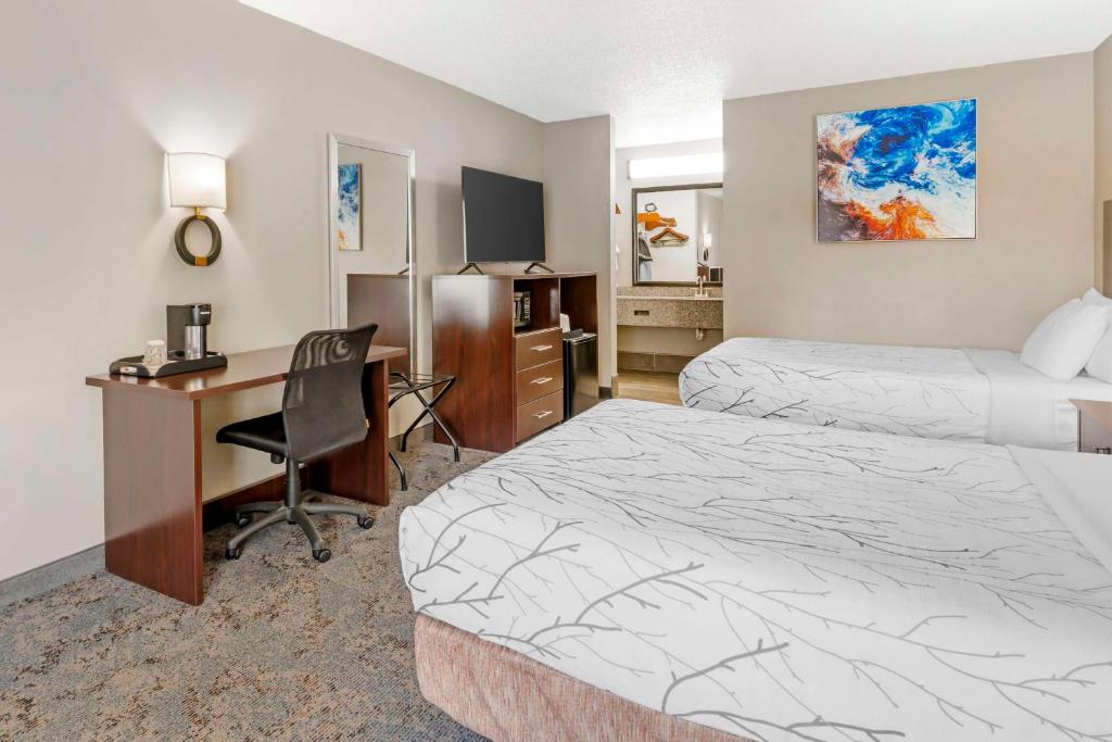 a hotel room with two beds and a desk at Best Western Royal Inn in Chattanooga