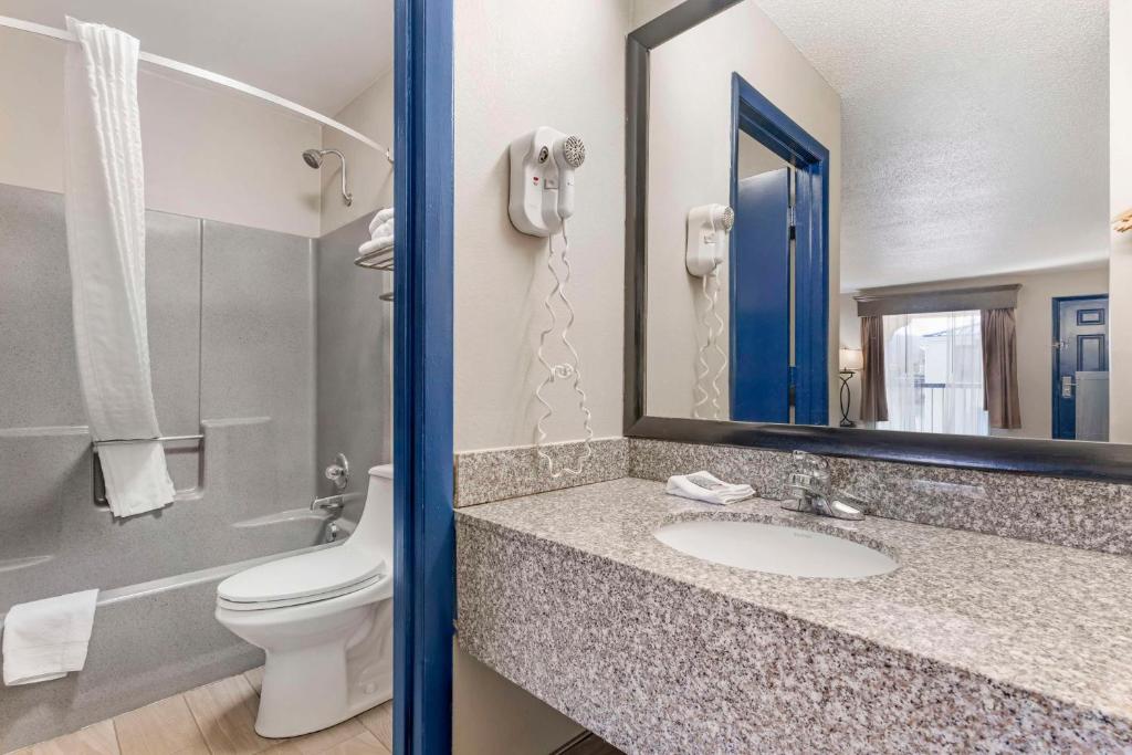 a bathroom with a sink and a toilet and a mirror at Best Western Royal Inn in Chattanooga