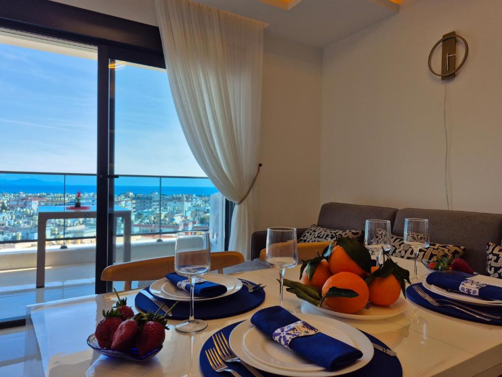 a dining room with a table with fruits and wine glasses at Luxury apartment with panoramic sea view ruby in Alanya