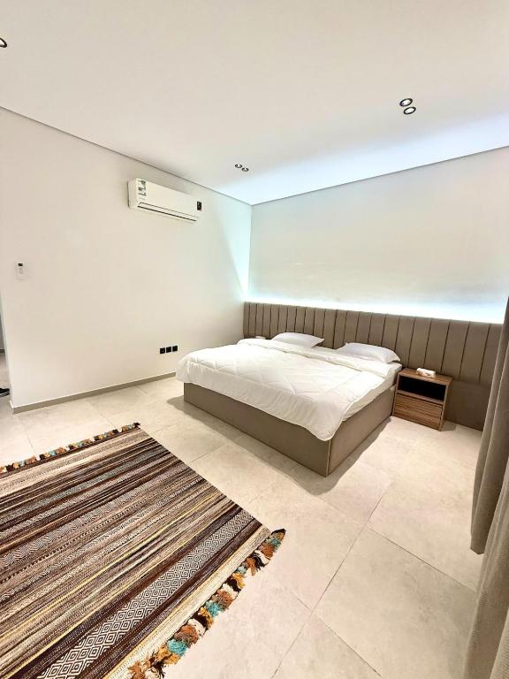 a bedroom with a bed and a rug on the floor at NOOR iNN , Prime Location, SelfEntry in Medina