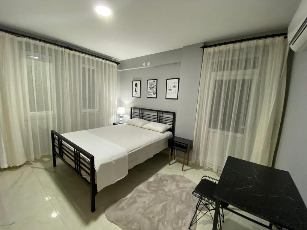 a bedroom with a large white bed and a table at Villa Pars Antalya Three story villa, private pool and roof terrace Three Bedroom Accommodation for six Guests in Belek