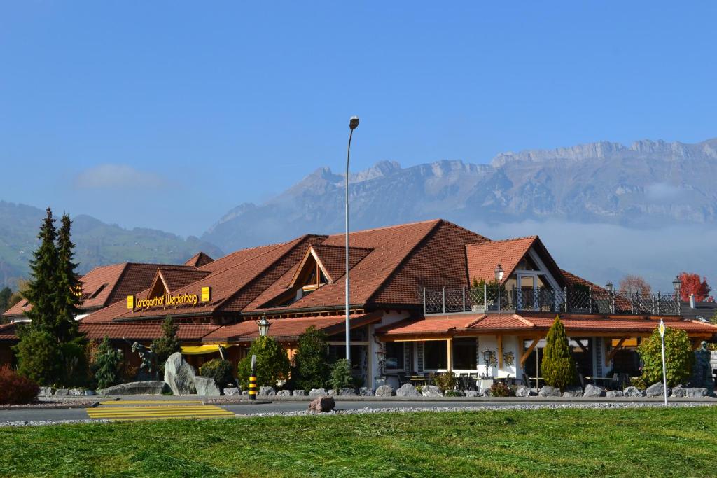 a building with a mountain in the background at Landgasthof Werdenberg in Werdenberg