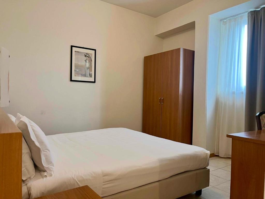 Łóżko lub łóżka w pokoju w obiekcie Hotel Napoleon