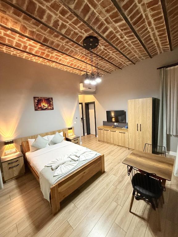 a large bedroom with a bed and a table at Taksim Millennium Alkan Residence in Istanbul