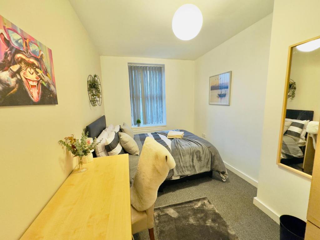 a bedroom with a bed and a table in it at Room 3 Shared House in L7 in Liverpool