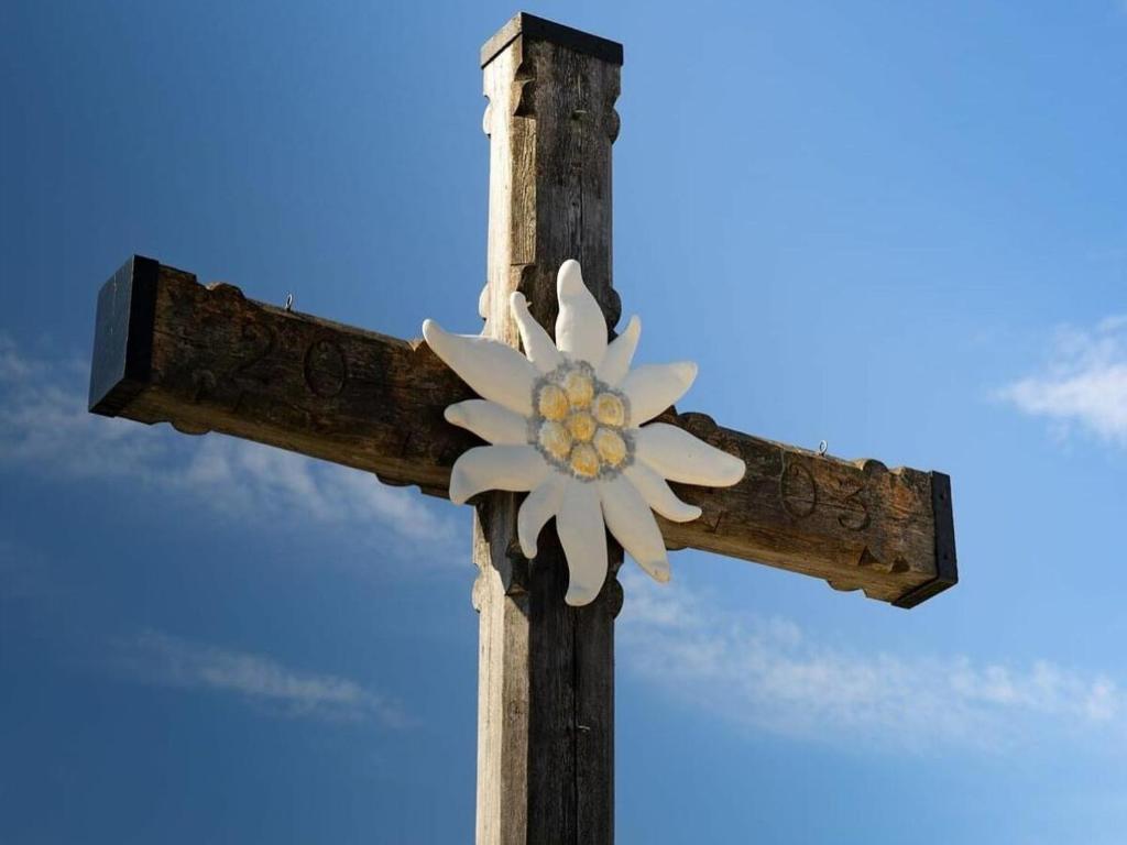 a wooden cross with a white flower on it at Ferienwohnung Sonnenglück in Schönau am Königssee