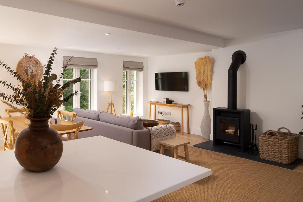 a living room with a couch and a fireplace at Clifftop Watch, River View and Balcony, 1 BR, Parking, Beach 10 min walk in Lynmouth