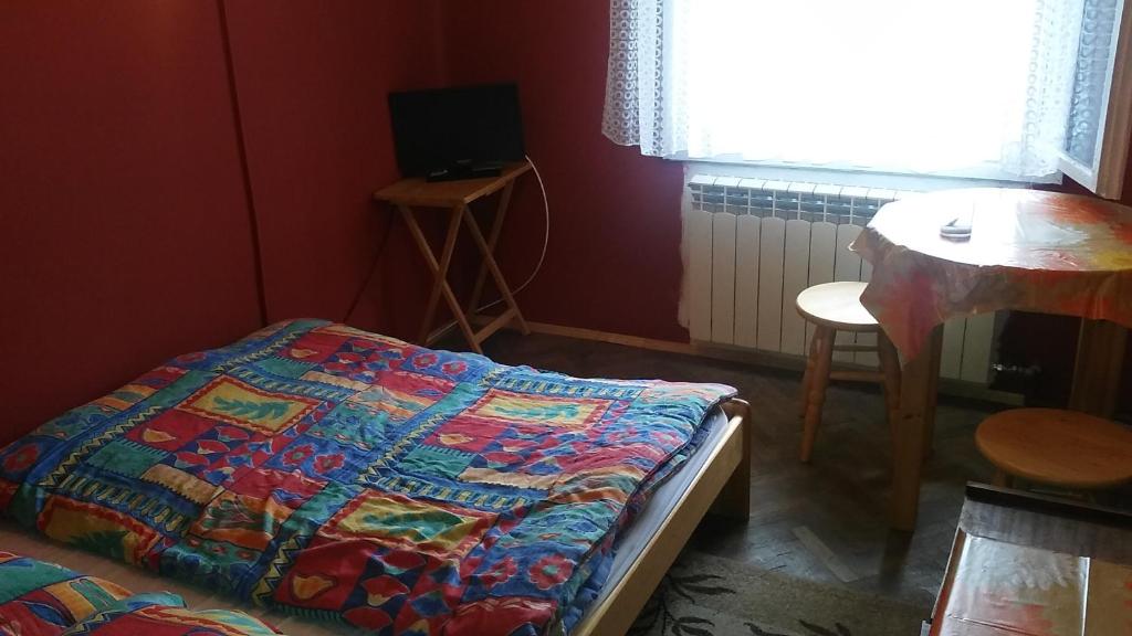 מיטה או מיטות בחדר ב-Pokoje Gościnne Monika Szling