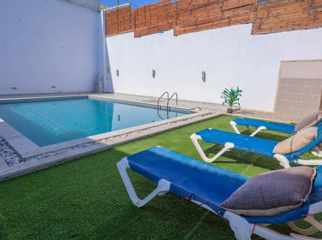 a swimming pool with two lounge chairs and a swimming pool at Jericho Palestine, Panorama Villa- View, Full Privacy & Pool in Jericho