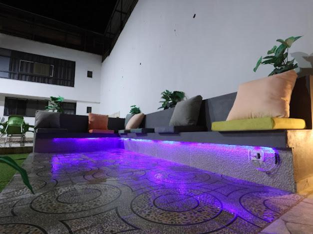 a living room with a couch with purple lighting at Jericho Palestine, Panorama Villa- View, Full Privacy & Pool in Jericho