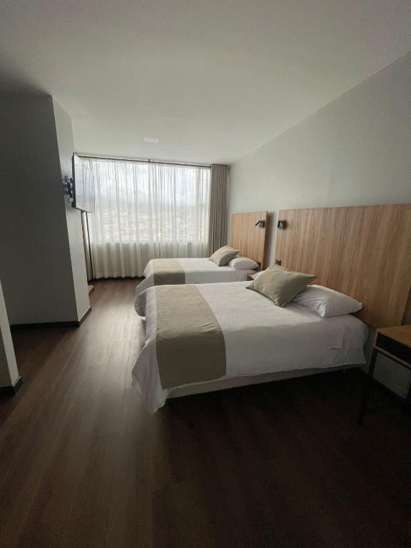 Postel nebo postele na pokoji v ubytování Universitario Hotel