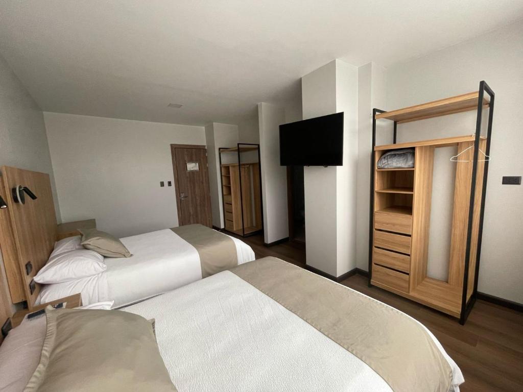 Postel nebo postele na pokoji v ubytování Universitario Hotel