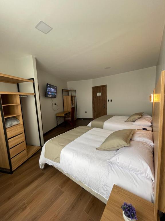 Postel nebo postele na pokoji v ubytování Universitario Hotel