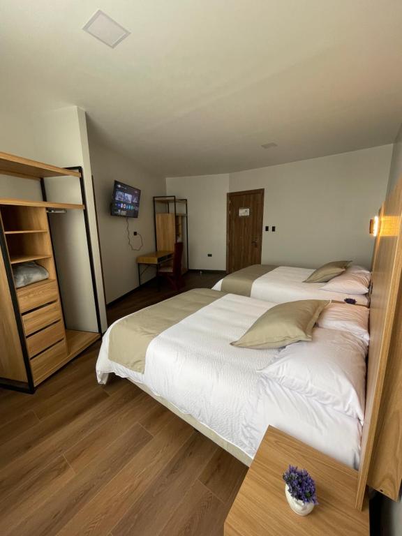 Postel nebo postele na pokoji v ubytování Universitario Hotel
